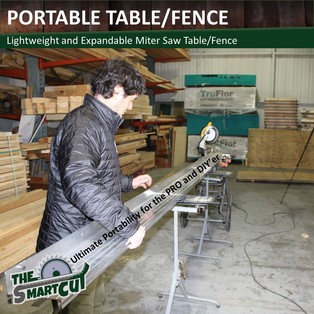 A person holding a 4.5‑foot anodized aluminum Smart Cut table/fence section attached to a portable miter saw stand in a workshop