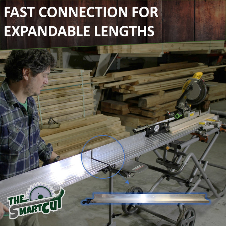 The Smart Cut aluminum rail fence attached to a portable miter saw table, showing the quick‑connect joint between two fence sections for extending length, with a person holding the fence steady
